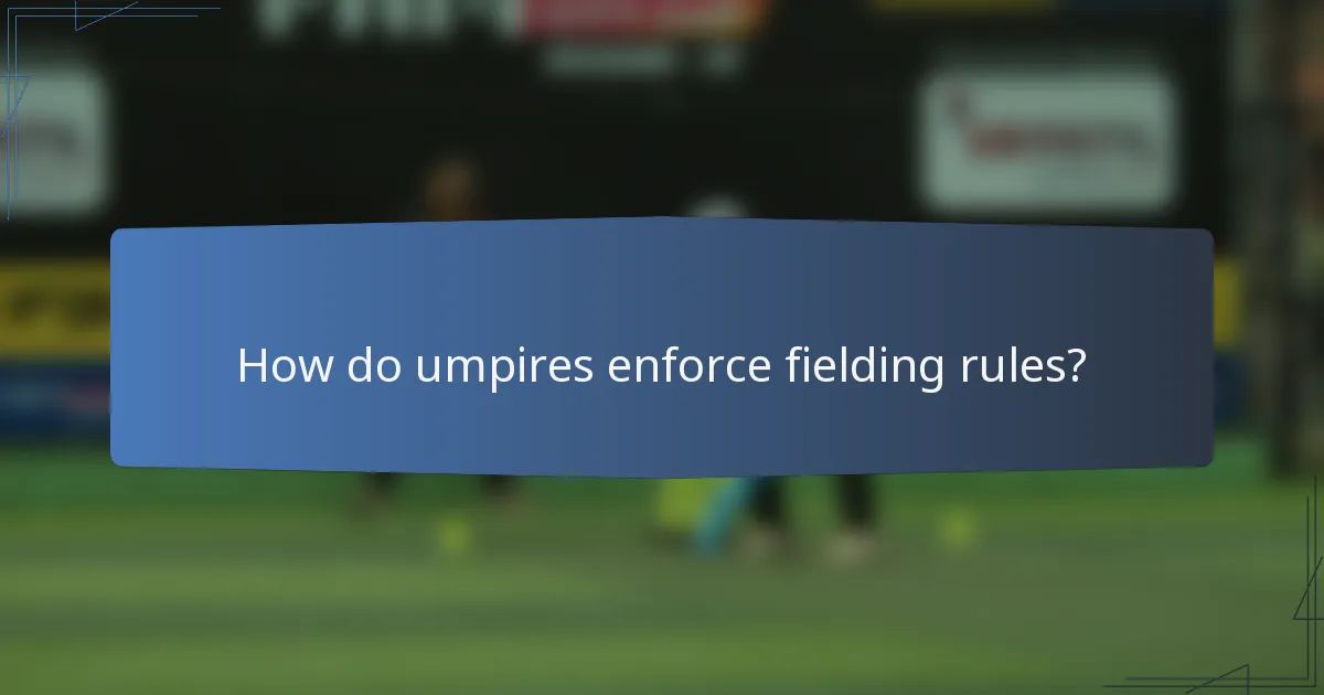 How do umpires enforce fielding rules?